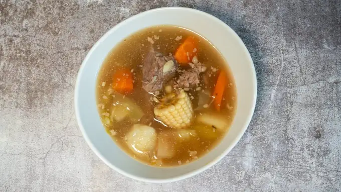 Cocido: beef soup with corn on the cob, carrots and potato