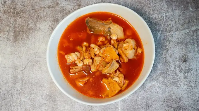 A bowl of soup in red broth